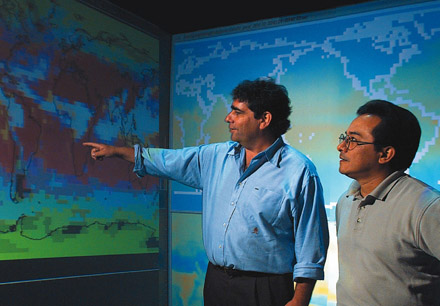 David Erickson (left) shows colleague José Hernandez a climate model map. [CREDIT: OAK RIDGE NATIONAL LABORATORY]