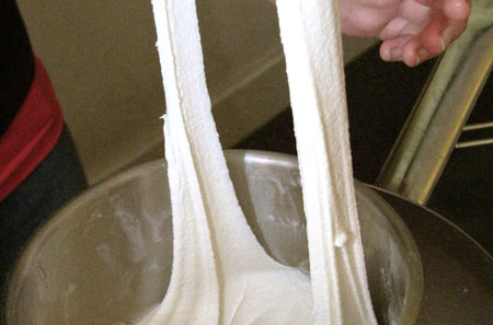 Stretchy ice cream in action: A chilled bowl of the stuff is stretched out during a demonstration. <br>[Credit: Anne E. McBride]