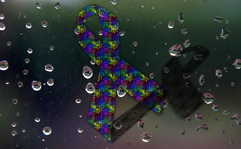 A ribbon with a jigsaw pattern symbolizes autism awareness.  Researchers question a study linking autism <br> incidence with high rainfall.  [Credit: Nikki K, Wikimedia Commons and freefotouk, flickr.com.  Compiled by <br> Shelley DuBois]