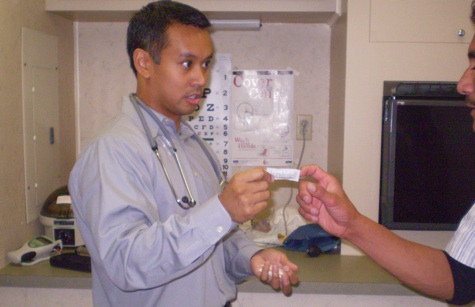 Ellery Tarife treating one of his patients on the mobile MedVan [Credit: Natalie Peretsman].