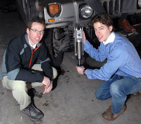 GenShock, a power-producing shock absorber, was designed by a team of MIT students including Ryan Bavetta (left) and Zack Anderson (right). [Credit: Donna Coveney, MIT]