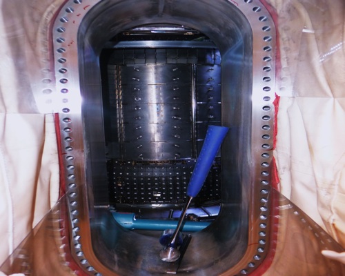 Fusion, a work in progress: This snap shot through the portal of MIT's tokamak fusion reactor shows the metallic core at the center of its donut-shaped cavity. At the time the photo was taken, the machine was under repair. [Credit: Robert Goodier]