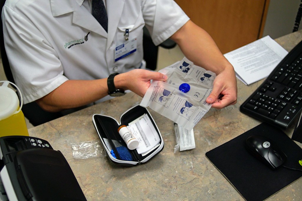 A medical worker packaging a naloxone kit