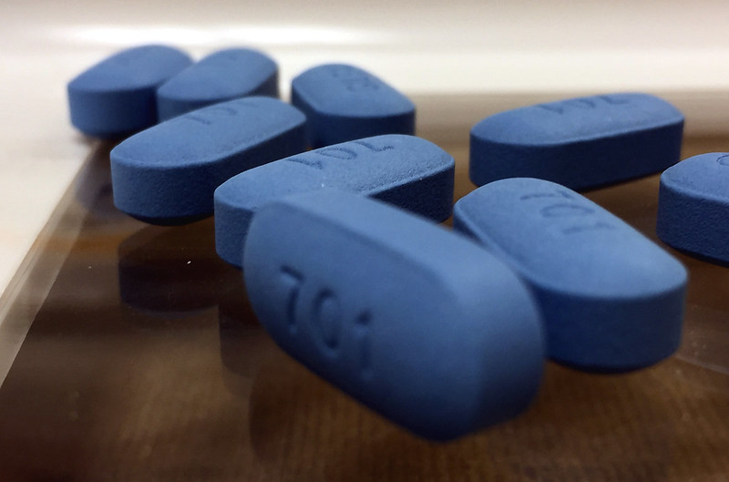 Eight pills of Truvada are depicted. Each are engraved to say 701. The pills are blue.