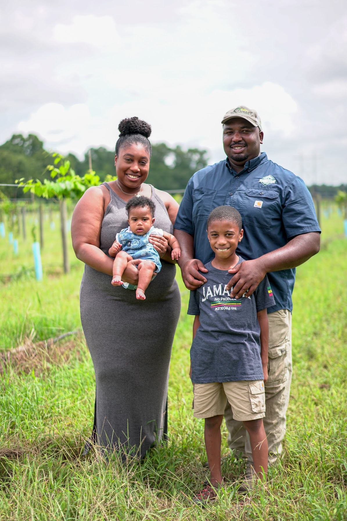 Davon Goodwin, his wife, Kenya Fuller, and their children standing on their farm
