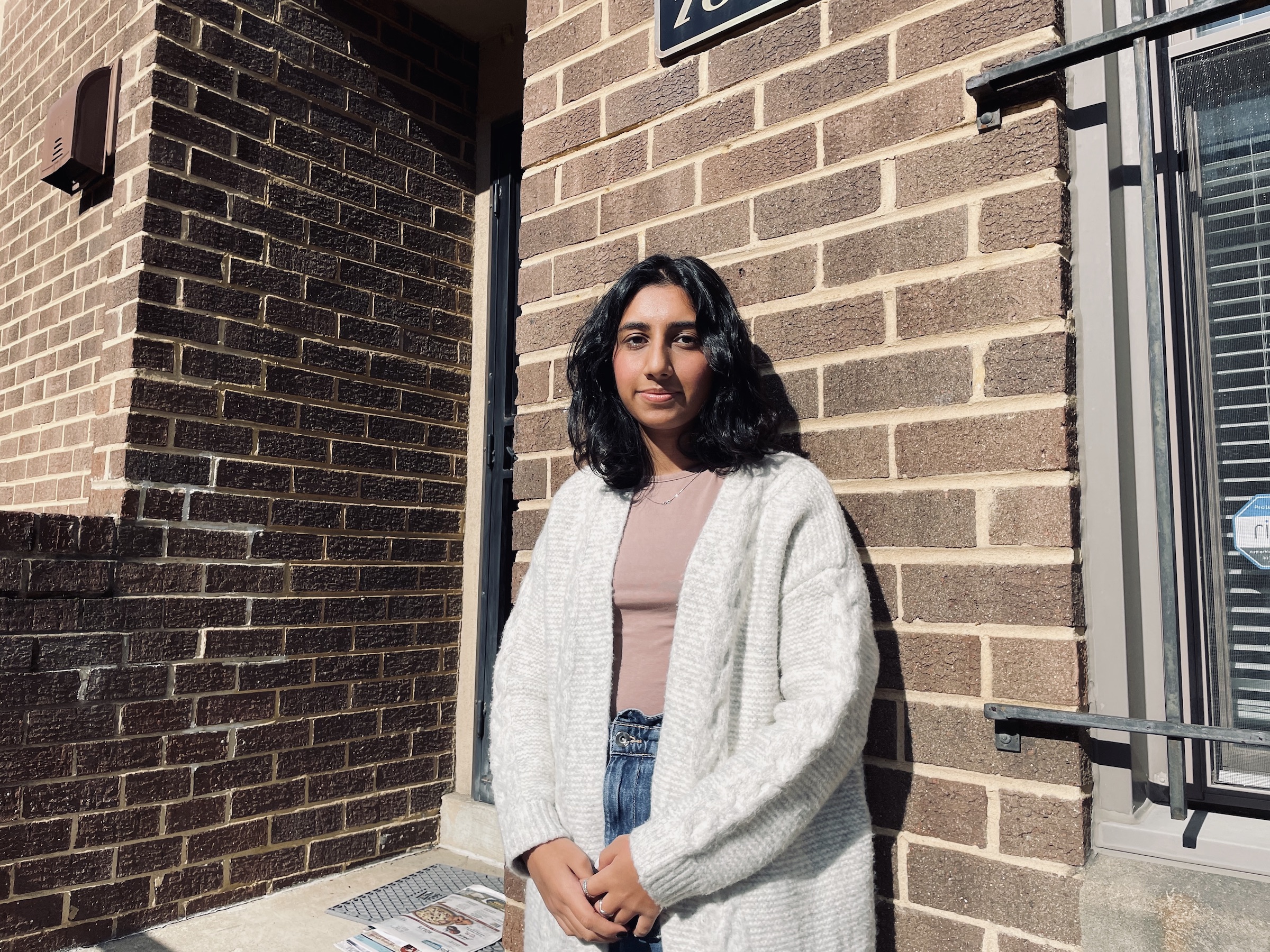 Nikita Dhar standing in front of a building