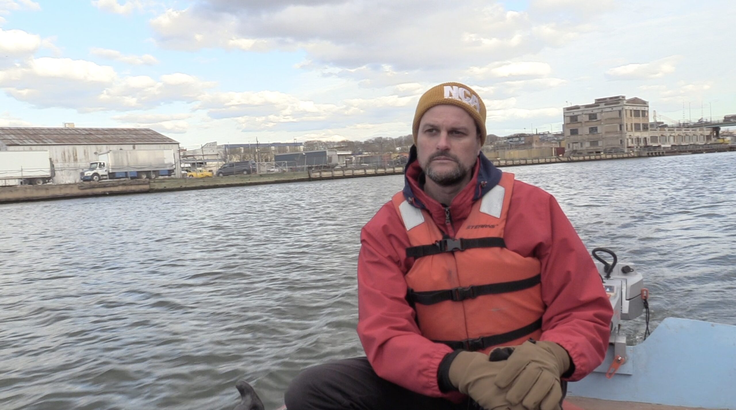 Man on boat at Newtown Creek