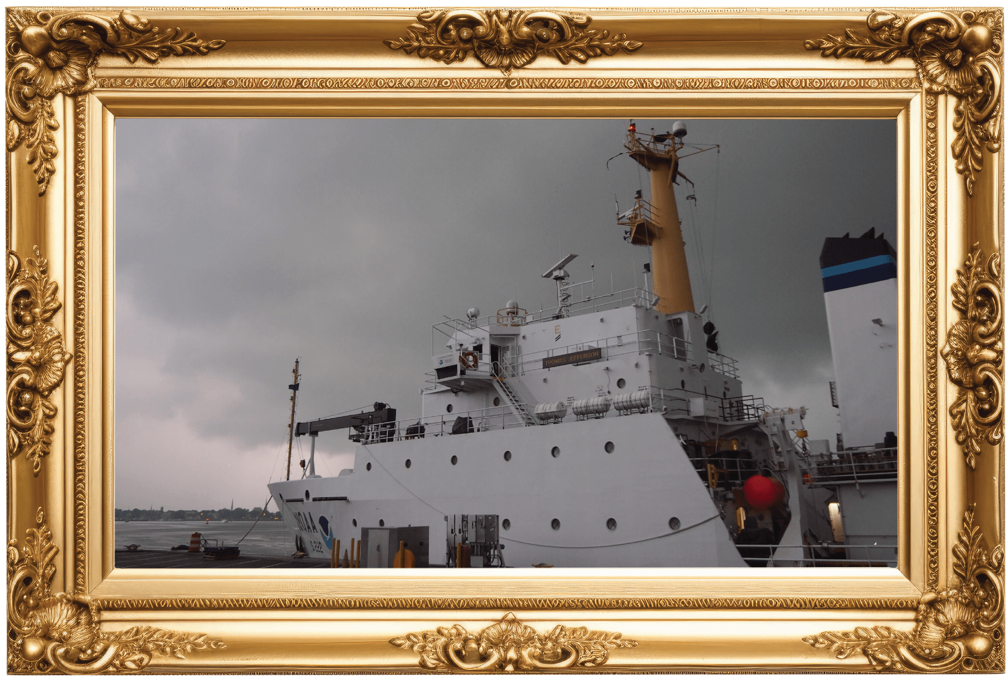 A NOAA research vessel docked in Norfolk, Virginia. The sky behind it is dark and stormy.