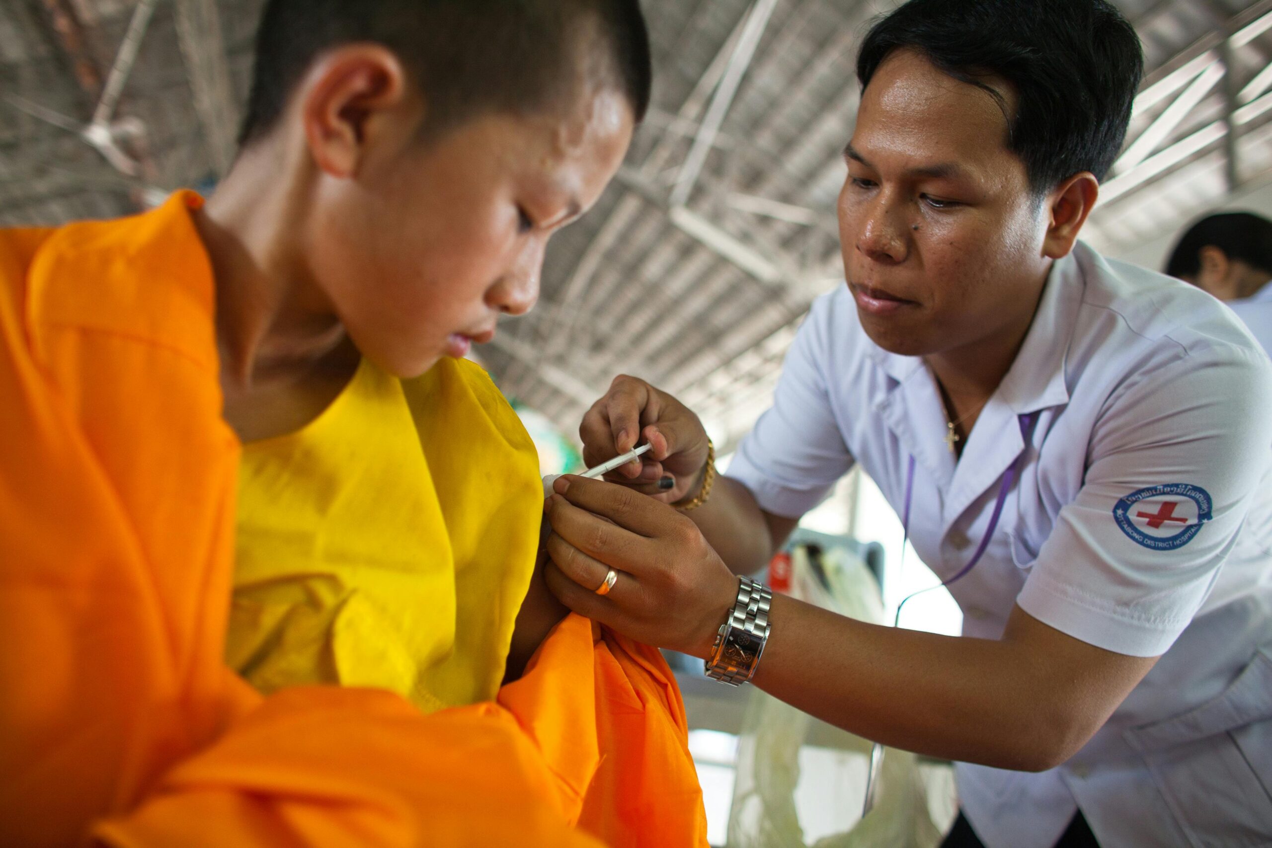 A child receives a vaccine in a clinic.